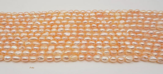 Freshwater pearl strands: orange semi-baroque 6-7×7-8mm irregular oval