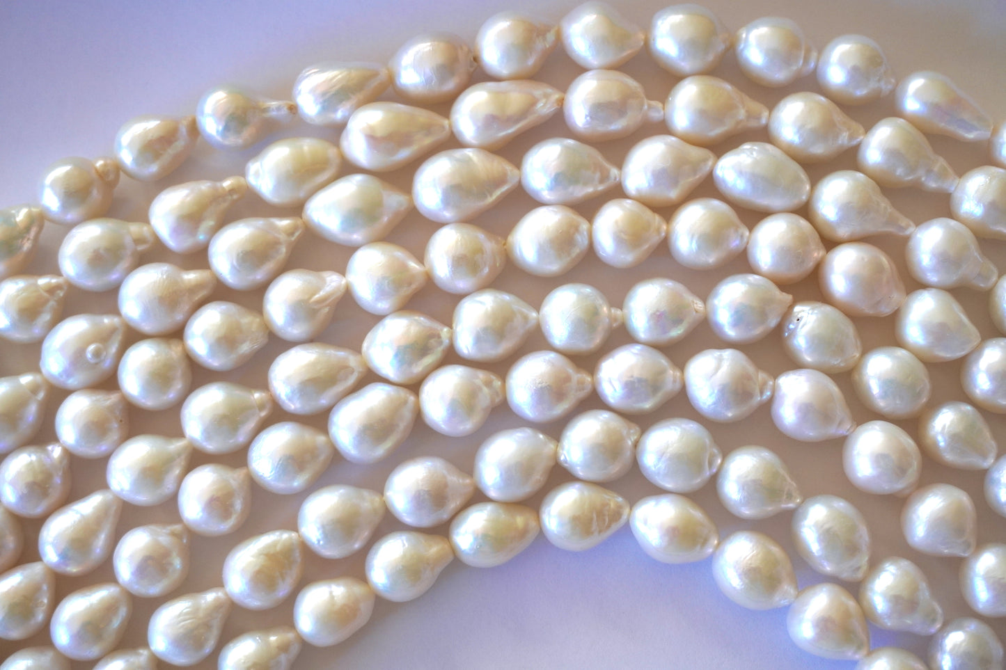 Freshwater pearl strands: Baroque white oval 12X10mm-14X10mm high grade