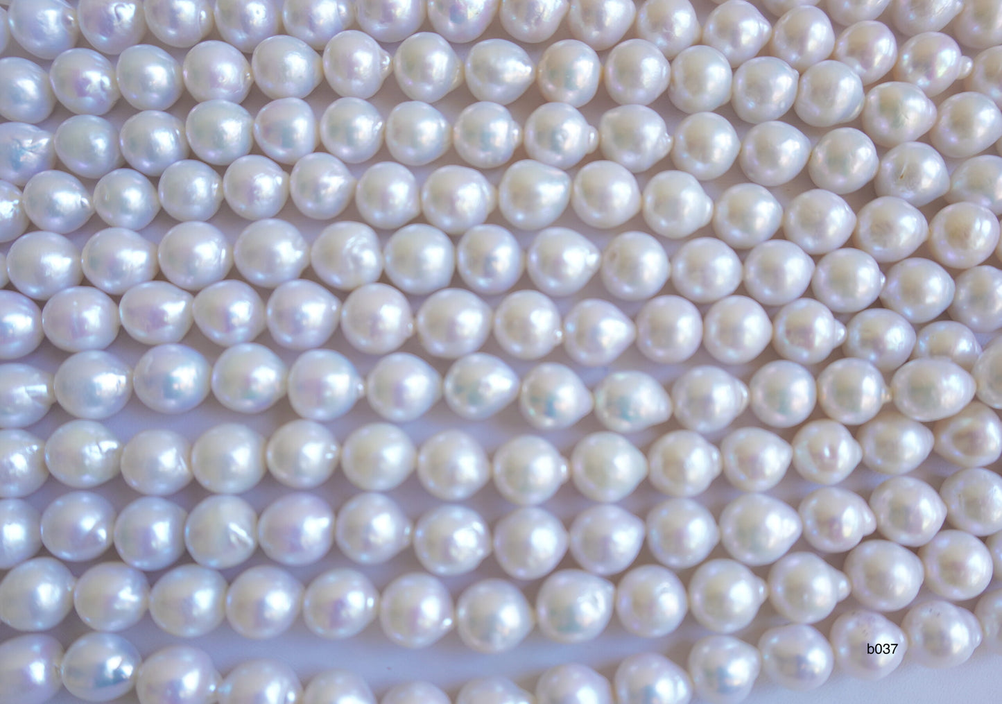 Freshwater pearl strands: Baroque white lustrous oval 13×11-11x10mm high grade